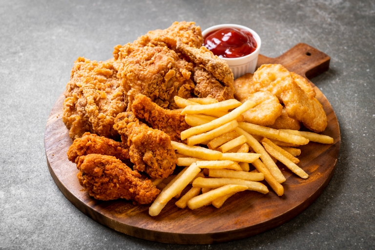 fried chicken with french fries and nuggets meal - junk food and unhealthy food